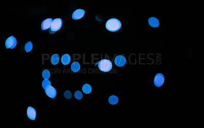 Buy stock photo Blue, confetti and bokeh in a studio with dark background for celebration, event or party. Lights, glitter and color sparkles for magic, shine or glow for festive by black backdrop with mockup.
