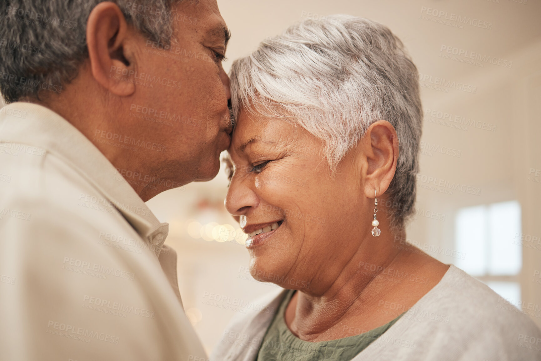 Buy stock photo Old couple, man kiss woman on forehead with love and bonding at home, love and life partner in marriage with peace. Commitment, trust and support with people in retirement, affection and romance