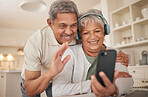 Home, video call and senior couple with love, smartphone and connection with internet, network and hello. Headphones, old man and elderly woman with a cellphone, online conversation and communication