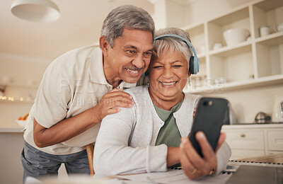 Buy stock photo Phone, hug and senior couple with video call in a kitchen happy, headphones and communication. Love, smile and old people with smartphone app for virtual, conversation or contact chat in their house