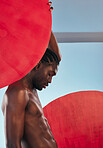 Art, body and black man profile with style, creative graphic and red dot with fitness and workout in studio. Blue background, male model and muscle with skin glow, power and strong chest with beauty