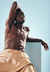 Muscle, art and black man with fitness, thinking and creativity on a blue studio background. African person, healthy guy and pose with model, beauty and wellness with fabric, artistic and aesthetic