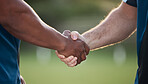 People, handshake and team sports for motivation, meeting or partnership together in nature. Closeup of athlete shaking hands in fitness, unity or teamwork for training, workout or outdoor exercise