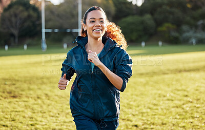 Buy stock photo Woman, running and training outdoor on field with smile, fitness and health in sunshine with vision at workout. Girl runner, exercise and happy for speed, wellness and thinking in summer on grass