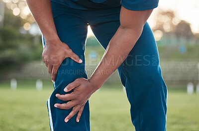 Buy stock photo Sports, injury and person on field with knee pain for accident, emergency and joint ache for muscle sprain. Fitness, healthcare and hands of athlete with strain from exercise, workout and training
