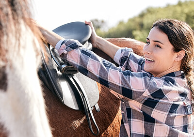 Horse, happy rider and woman with saddle on ranch for animal care, training and riding on farm. Agriculture, countryside and person with seat for stallion for practice, freedom and adventure outdoors