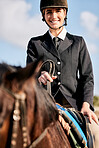 Portrait, equestrian and a woman jockey with her horse on a ranch for sports, training or a leisure hobby. Smile, riding or competition and a happy young rider in uniform with her stallion outdoor