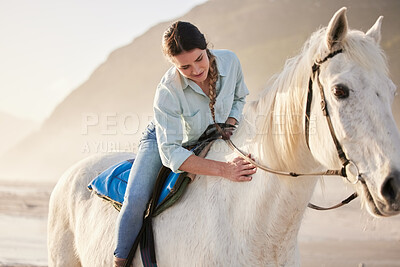 Beach, equestrian and woman riding her horse outdoor on a summer morning for training or practice. Nature, sunset and a young rider on horseback with her pet animal by the ocean or sea to relax