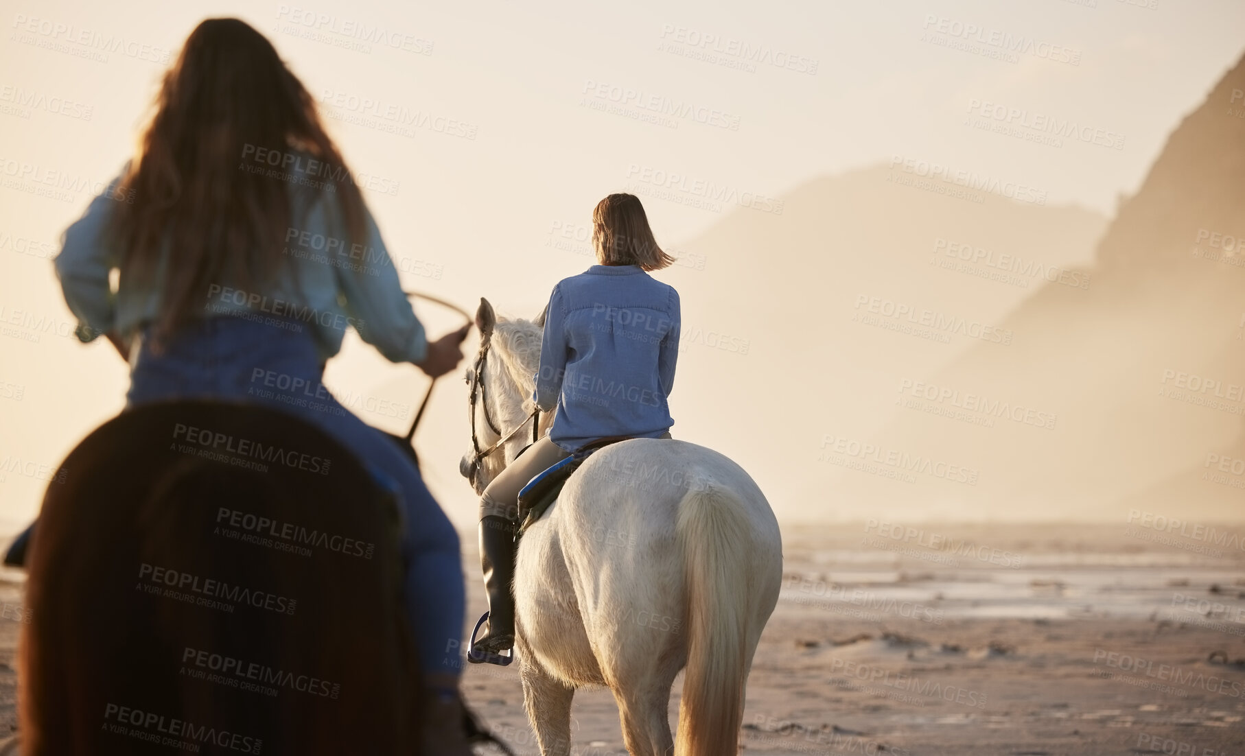 Buy stock photo Woman, horse riding and activity at beach, together and back view for exercise, wellness or health. Female, person or friends with workout on vacation, holiday and traveling at sunset for self care