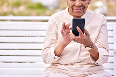 Buy stock photo Senior woman, phone and park outdoor with social media scroll and text sitting on a garden bench. Hands, elderly female person and smile from mobile networking, internet app and online reading 