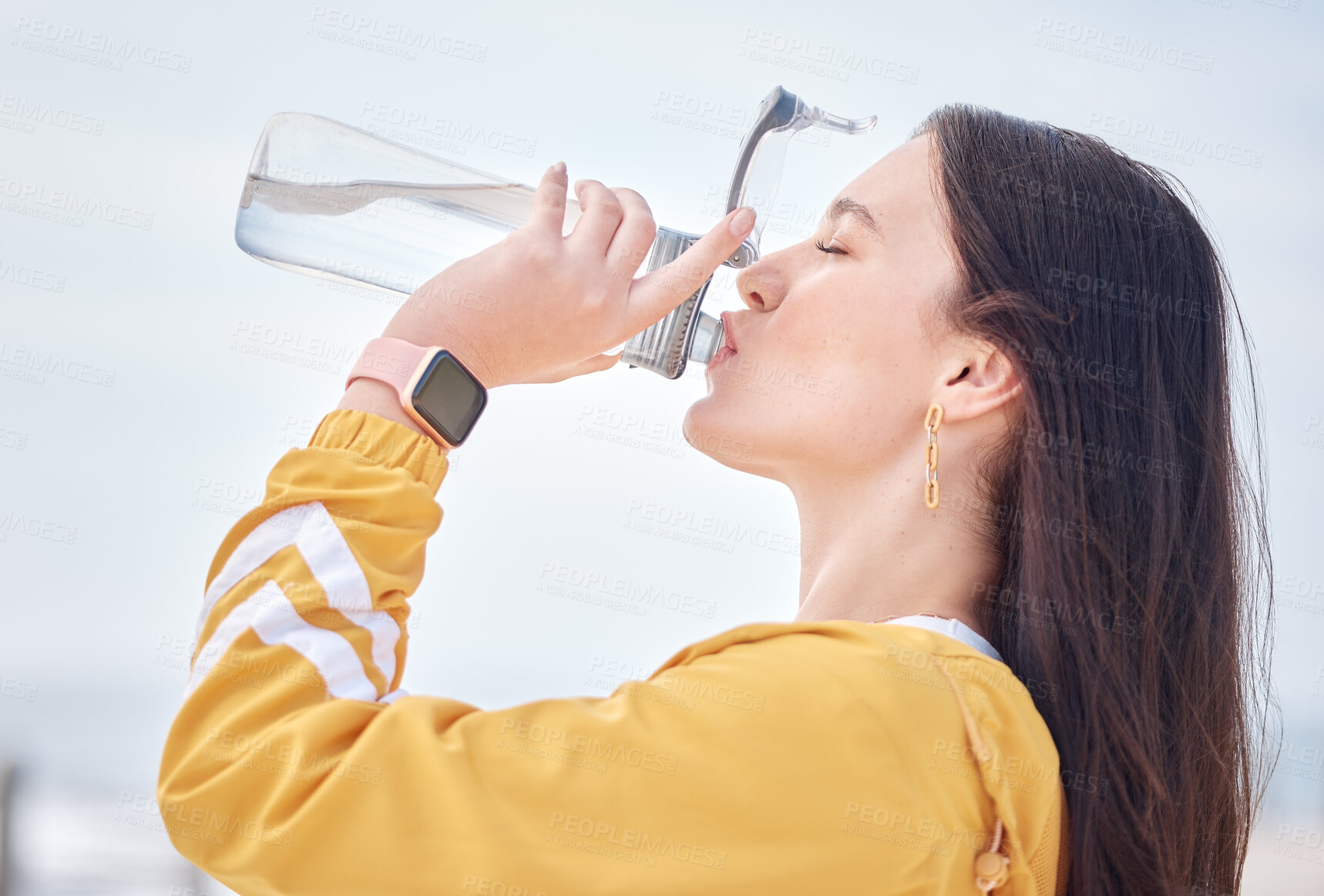 Buy stock photo Woman, drinking water and outdoor with bottle to relax, rest and detox body in training, exercise or running. Drink, liquid and healthy hydration in summer morning with athlete and self care 