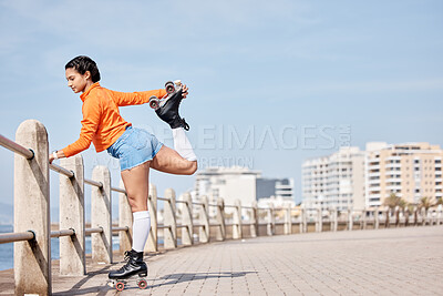 Buy stock photo Roller skate, stretching and mockup with a girl at the promenade on a blue sky background for the weekend. Fitness, beach and balance with a young person skating outdoor during summer on banner space