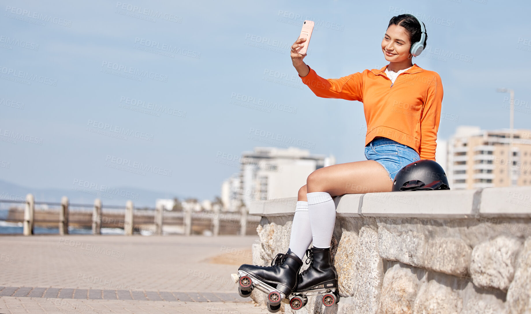 Buy stock photo Skating, woman and selfie outdoor for social media, internet post or profile picture in nature. Sports, person and headphones by ocean, park or sea for relax, freedom and happiness with roller skates