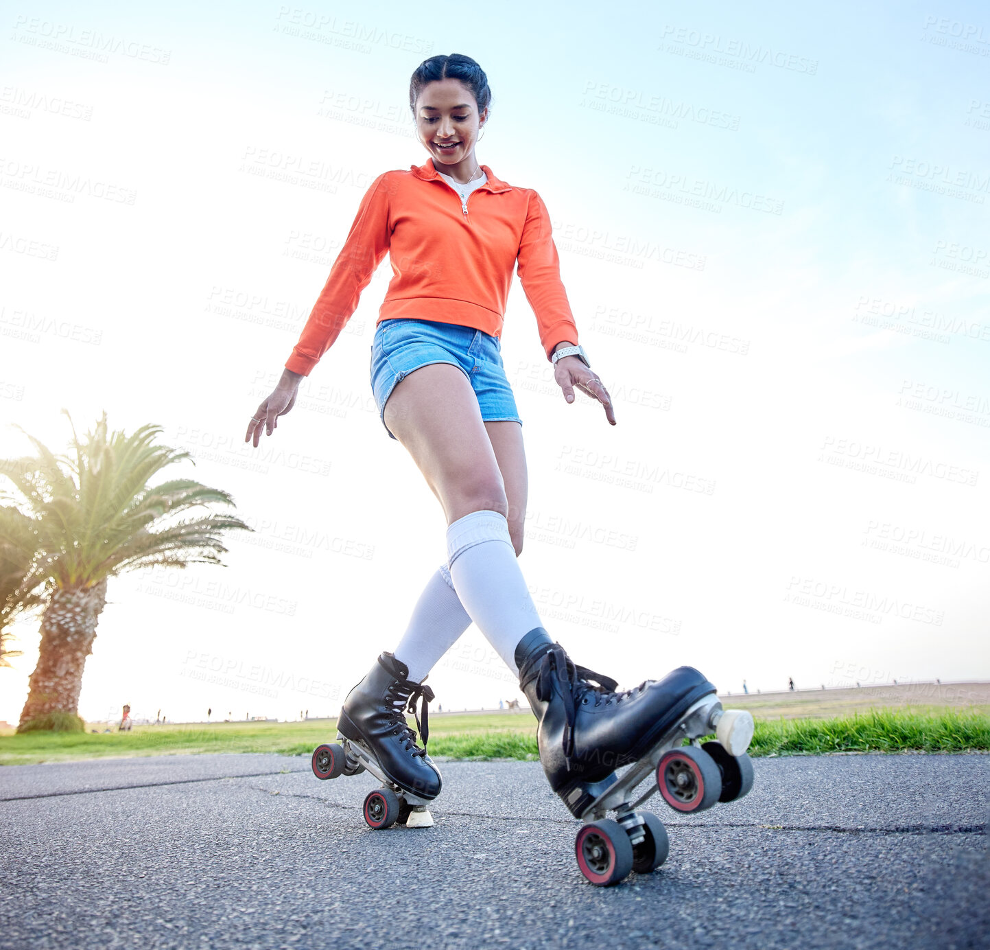 Buy stock photo Happy, woman and skating outdoor on sidewalk with wheel, shoes and legs in cardio, exercise or summer workout. Fitness, training and girl roller skate on beach pavement, ground or balance on feet