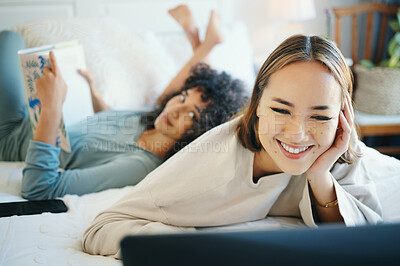 Buy stock photo Laptop, smile and a lesbian couple reading in bed while together in their home on the weekend. Diversity, computer and a happy lgbt woman with her girlfriend in the bedroom for love or bonding