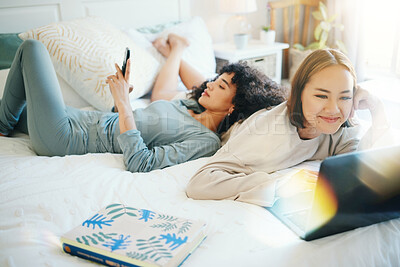 Buy stock photo Relax, laptop and social media with a lesbian couple in bed together in their home on the weekend. Diversity, smile and a happy lgbt woman with her girlfriend in the bedroom for love in the morning