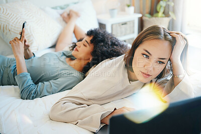 Buy stock photo Laptop, social media and morning with a lesbian couple in bed together in their home on the weekend. Diversity, computer and an lgbt woman browsing with her girlfriend in the bedroom for love