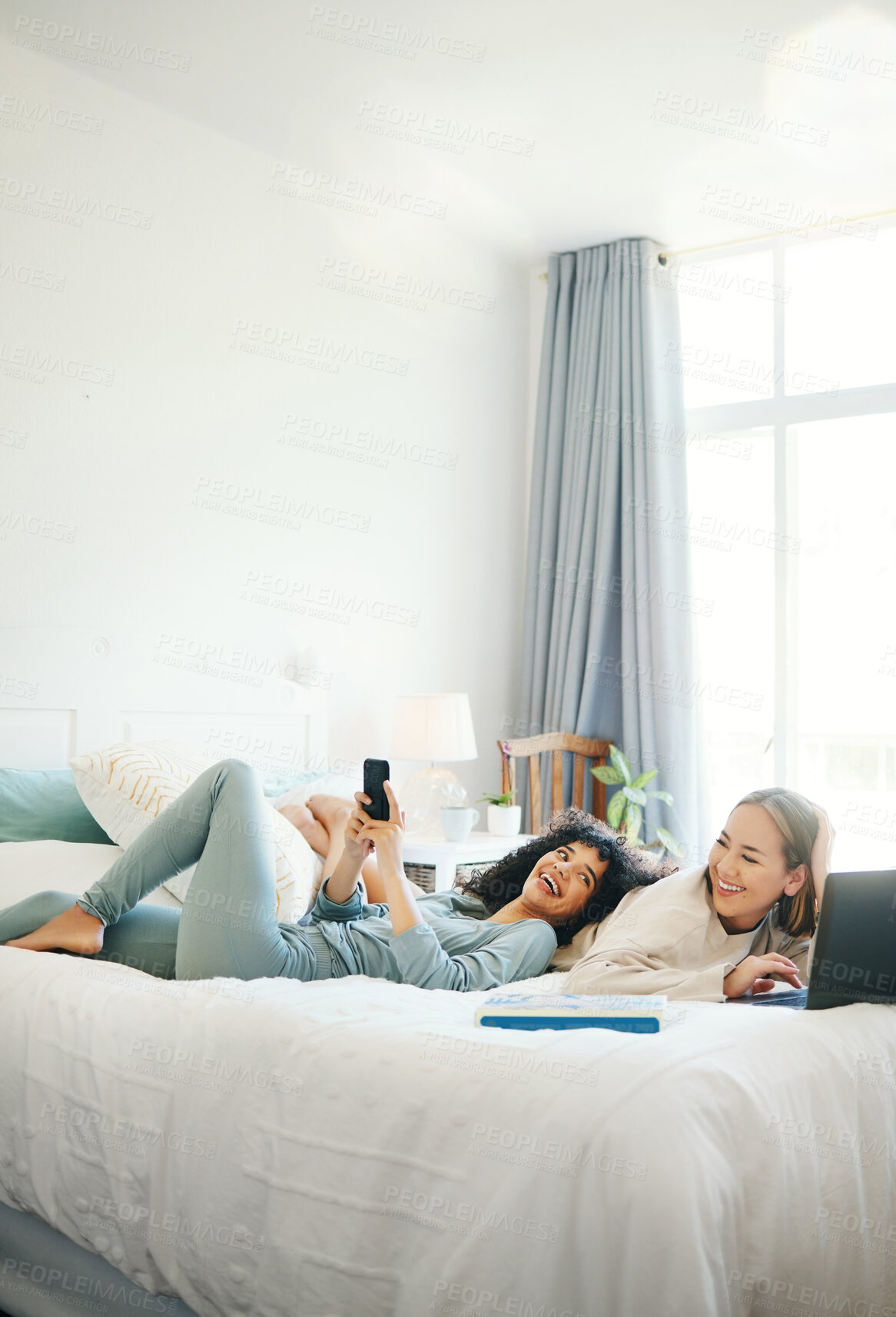 Buy stock photo Technology, social media and morning with a lesbian couple in bed together in their home on the weekend. Relax, diversity and an lgbt woman with her girlfriend in the bedroom for love or bonding