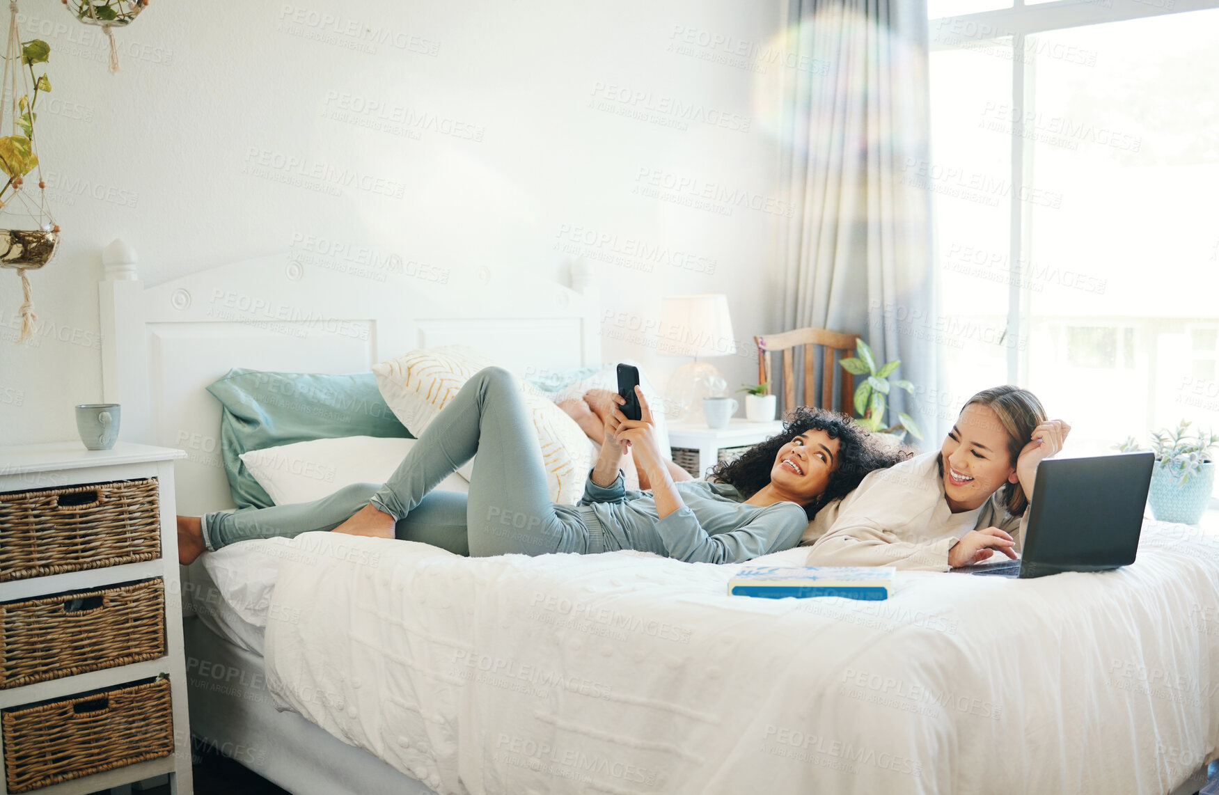 Buy stock photo Relax, morning and a lesbian couple on the internet in bed together in their home on the weekend. Diversity, technology and a happy lgbt woman with her girlfriend in the bedroom for love or bonding