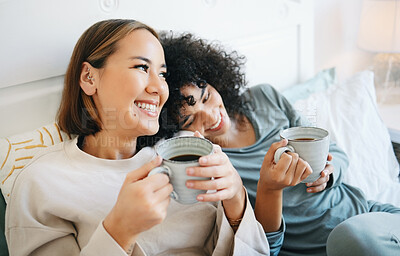 Buy stock photo Coffee, communication and happy lesbian couple on bed  bonding and relaxing together. Happy, rest and young interracial lgbtq women laughing, talking and drinking latte in bedroom of modern apartment