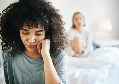 Buy stock photo Lgbtq, woman and sad for couple fight in bedroom of home with conflict, crisis or problem in relationship. Lesbian, partner and girl on bed with stress, anxiety and depressed for argument and divorce