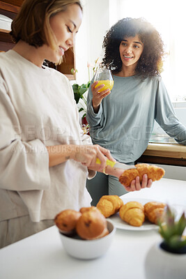 Buy stock photo Couple, happiness and women with juice and food in kitchen for breakfast, nutrition and vitamin c in morning. Cooking, people and smile with drink and pajamas or natural face for wellness or fruit