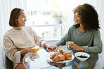 Orange juice, coffee and happy lesbian couple holding hands in home at table bonding together. Smile, support and gay women in love in the morning at breakfast, LGBT care and interracial relationship
