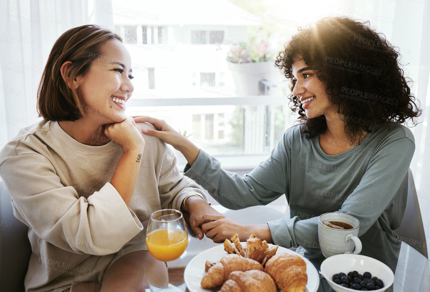 Buy stock photo Breakfast, lgbtq and couple in morning in home eating together for bonding, love and care. Sunrise, lesbian and happy women with food for healthy relationship, nutrition and share meal for romance