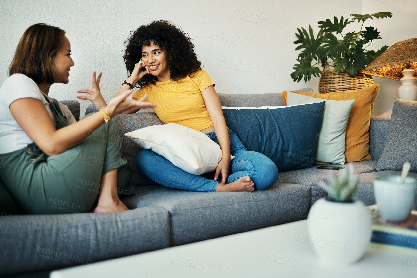 Buy stock photo Women, friends and conversation in a home with gossip, discussion and happy in a living room. Couch, smile and people on a sofa with gossip or social together in a house lounge with speaking together