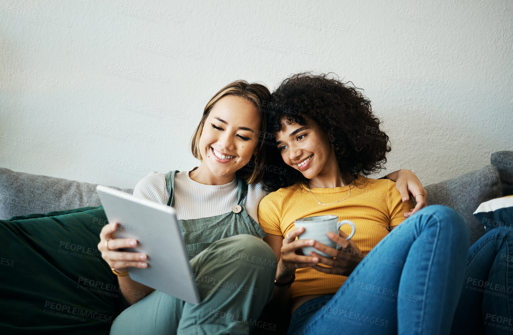 Buy stock photo Relax, happy and a lesbian couple with a tablet on the sofa for social media, internet or a movie. Coffee, house and gay or lgbt women with technology for streaming a film or show on the couch