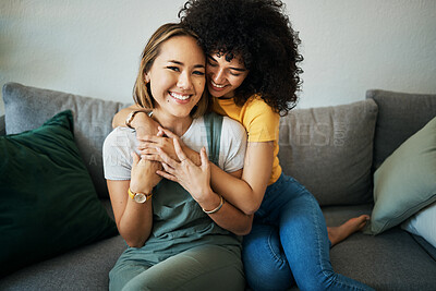 Buy stock photo Lgbt, couple and portrait of hug on sofa in home, living room or apartment with love, support and happiness. Lesbian, women and embrace together with smile on face on lounge couch in new house