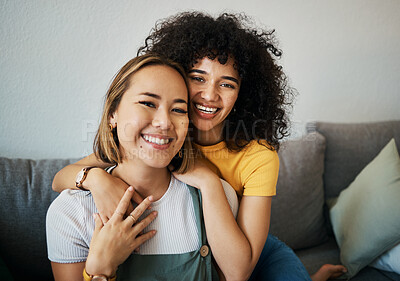 Buy stock photo Lesbian, couple and portrait of hug on sofa in home, living room or apartment with love, support and happiness. Lgbt, women and embrace together with smile on face on lounge, relax and couch in house