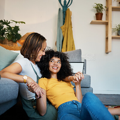Buy stock photo Lesbian, couple and relax on couch in communication at home for support, trust and partnership. Happy lgbt woman, living room or smile for identity or equality love in house, commitment or together