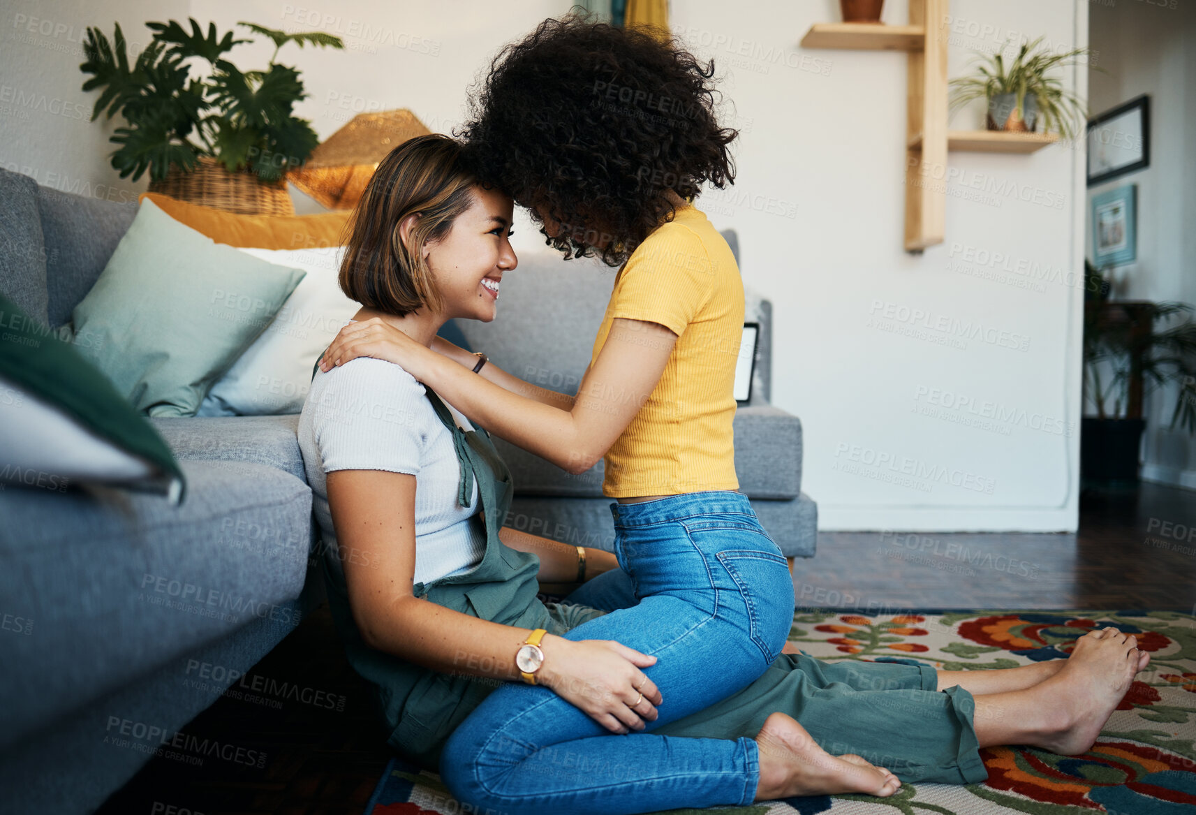 Buy stock photo Lgbtq, couple and love with hug on a living room floor in new home with smile of lesbian women. Gay marriage, happy and together with care and support in a lounge with embrace sitting on the ground