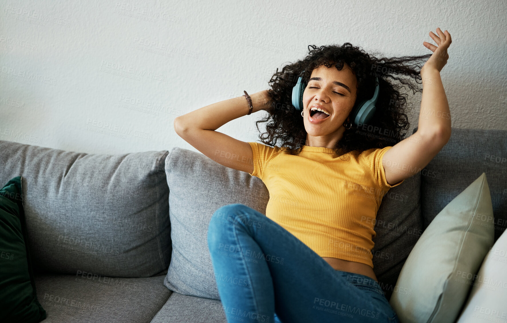 Buy stock photo Music, headphones and happy woman sing on a sofa with podcast, album or audio track at home. Radio, earphones and female person in living room with feel good fun subscription, streaming or freedom