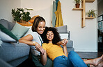 Lesbian, couple and relax on couch for connection in home for support, quality time or partnership. Happy woman, sofa and smile for identity or equality love in house for commitment, together or care