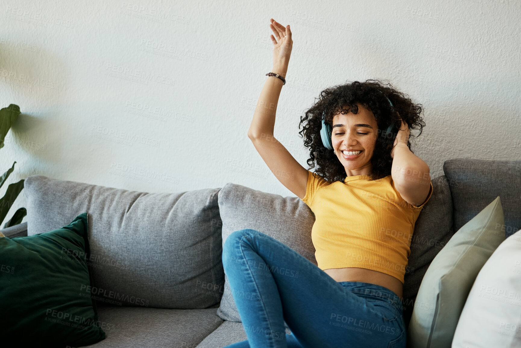 Buy stock photo Headphones, music and woman dance on a sofa with podcast, album or audio track at home. Radio, earphones and female person having fun in living room with feel good subscription, streaming or freedom
