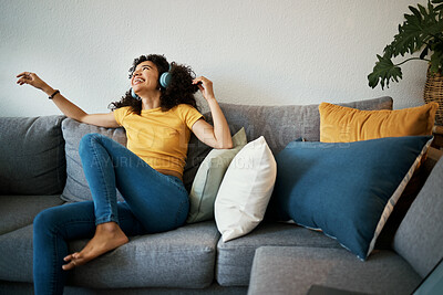 Buy stock photo Happy, freedom and woman on a sofa with music, headphones or subscription at home. Podcast, earphones and female person having fun with radio, streaming or online audio, track or album in living room