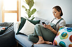 Woman, relax on sofa with smartphone and chat online with communication, wellness and reading text message. Email, technology and mobile app with virtual conversation, typing on social media at home