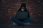 Hacker, woman in basement with laptop and information technology, phishing and cyber crime with database or server. Cybersecurity, programming and criminal with pc, ransomware and firewall breach