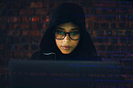 Hacker, woman in basement and laptop, coding and IT with code overlay, database with phishing and cyber crime. Cybersecurity, programming or hacking, criminal with pc for ransomware and firewall