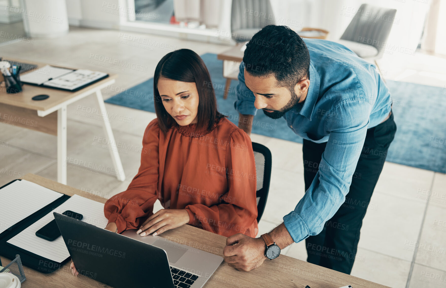 Buy stock photo Employee, manager and office with laptop with creative director, above and feedback on project. Diversity, man and woman for consulting by technology, performance review and concern with job progress