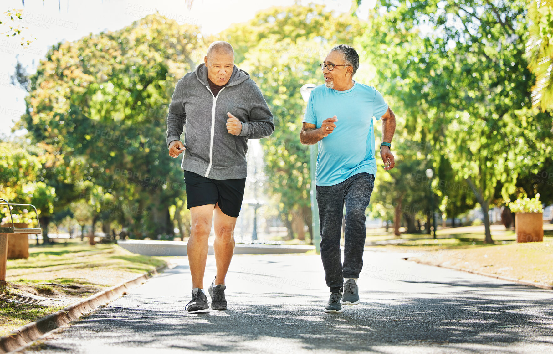 Buy stock photo Senior, men and running for workout in road of city for wellness, exercise or fitness outdoor with smile. Elderly, people and training together in nature or park for health, adventure and happiness