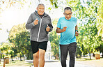 Senior, men and running for training in road of city for wellness, exercise or workout outdoor with smile. Elderly, people and fitness together in nature or park for health, adventure and happiness