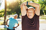 Happy senior man, stretching and fitness in park for running, exercise or outdoor training in nature. Mature male person in body warm up, arm stretch or preparation for cardio workout or wellness