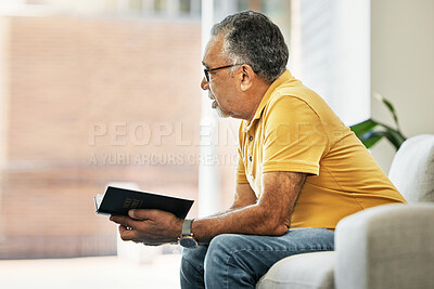 Buy stock photo Senior man, thinking and reading a book on sofa in home living room learning knowledge, information or ideas. Elderly, person and relax in retirement with novel, books or inspiration for fiction