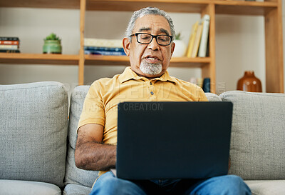 Buy stock photo Typing, senior man and laptop on sofa in home with online research in living room or streaming video, movies or tv show. Elderly, person or writing on computer in retirement for blog or communication