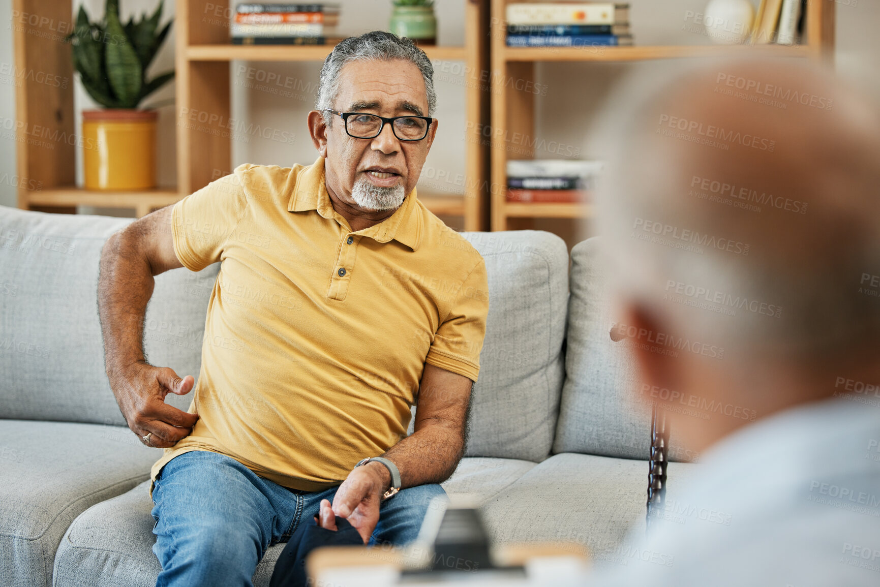 Buy stock photo Doctor, consultation and senior man on sofa with walking stick or discussion of pain in physical therapy with checklist. Therapist, consulting and talking elderly patient on couch in rehabilitation