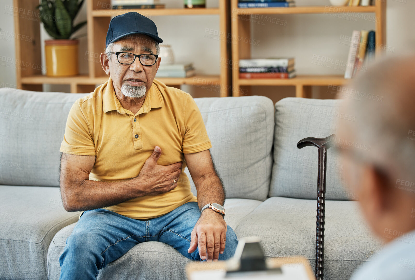 Buy stock photo Consulting, doctor and senior man on sofa in therapy with walking stick for counselling discussion with checklist of pain. Elderly patent, talking and therapist for anxiety or mental health service