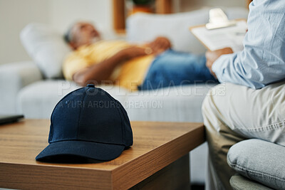 Buy stock photo Cap, help and man in therapy for stress, conversation and discussion about mental health. Anxiety, psychology and closeup of hat on table in counseling for advice, notes or support from psychologist